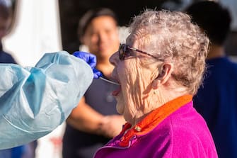 MELBOURNE, AUSTRALIA - JUNE 28: An elderly woman is tested at a pop-up clinic during a COVID-19 testing blitz in the suburb of Broadmeadows on June 28, 2020 in Melbourne, Australia. Victoria's confirmed COVID-19 infection numbers continue to rise, with 49 new coronavirus cases recorded overnight. Health authorities are continuing on a testing blitz in Melbourne suburbs that have been identified as community transmission hotspots for coronavirus. Restrictions in Victoria have been tightened in response to the spike in new cases across the state with premier Daniel Andrews extending the current state of emergency for at least four weeks to allow police the power to enforce social distancing rules. (Photo by Asanka Ratnayake/Getty Images)