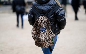 PARIS, FRANCE - JANUARY 20: A guest wears a leopard print JanSport backpack, outside Kenzo, during Paris Fashion Week - Menswear F/W 2019-2020, on January 20, 2019 in Paris, France. (Photo by Edward Berthelot/Getty Images)