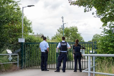 MUENSTER, GERMANY - JUNE 07: Police guards stand outside a garden colony following the arrest of 11 people in a paedophile case on June 07, 2020 in Muenster, Germany. According to police a 27-year-old computer specialist used the garden house as a venue for providing his girlfriend's 10-year-old son and a 5-year-old boy to be filmed having sex with other men. Police have conducted raids on 12 locations so far and confiscated 500 terabytes worth of digital material. They have also identified one more victim, aged 12, though they say they fear they are only at the tip of the iceberg. (Photo by Lukas Schulze/Getty Images)