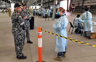 Surgeon General of the Australian Defence Force, Rear Admiral Sarah Sharkey (L), speaks to defence personnel manning a COVID-19 coronavirus drive-through testing station in Melbourne on June 29, 2020. - The nation's second-biggest city, Melbourne, has seen a surge in COVID-19 cases over the past week, with another 75 reported in the last 24 hours. (Photo by William WEST / AFP) (Photo by WILLIAM WEST/AFP via Getty Images)