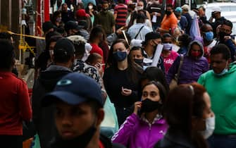 SAO PAULO, BRAZIL - JUNE 29: Shoppers wearing face masks walk in a crowded street in downtown amidst the coronavirus (COVID-19) pandemic on June 29, 2020 in Sao Paulo, Brazil. The city of Sao Paulo moves to the Yellow phase of quarantine easing, in which commercial establishments can operate following distance rules such as reduced opening hours, restricting the flow of people and maintaining hygiene standards. (Photo by Alexandre Schneider/Getty Images)