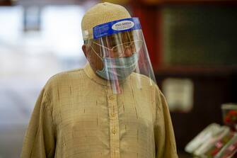 LEICESTER, ENGLAND - JUNE 30: A man wearing a face mask and shield shops in Leicester market  before non-essential shops close for the localised pandemic lockdown on June 30, 2020 in Leicester, England. As the rest of England prepares to reopen pubs and restaurants this weekend, Leicester is closing all non-essential businesses again after a spike in coronavirus cases worried officials. (Photo by Christopher Furlong/Getty Images)