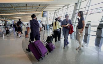 SAN DIEGO, CA-MAY20:  Passengers Check-in for their flights at San Diego International Airport on May 20, 2020 in SanDiego, California. Air travel is down as estimated 94 percent due to the coronavirus (COVID-19) pandemic, causing U.S. airlines to take a major financial hit with losses of $350 million to $400 million a day and nearly half of major carriers airplanes are sitting idle. (Photo by Sandy Huffaker/Getty Images)