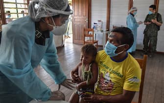 1223660106 Members of the Brazilian Armed Forces medical team take a COVID-19 test from a member of the indigenous Ye'Kuena ethnic group, at the 5th Special Frontier Platoon in Auari, Roraima state, Brazil, on June 30, 2020, amid the novel coronavirus COVID-19 pandemic. (Photo by NELSON ALMEIDA / AFP) (Photo by NELSON ALMEIDA/AFP via Getty Images)