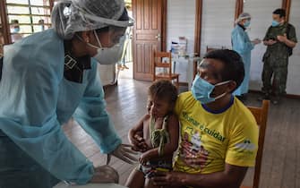 Members of the Brazilian Armed Forces medical team take a COVID-19 test from a member of the indigenous Ye'Kuena ethnic group, at the 5th Special Frontier Platoon in Auari, Roraima state, Brazil, on June 30, 2020, amid the novel coronavirus COVID-19 pandemic. (Photo by NELSON ALMEIDA / AFP) (Photo by NELSON ALMEIDA/AFP via Getty Images)