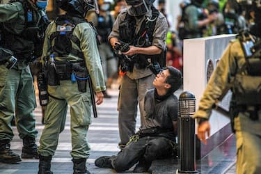 A protester (centre R) is detained by police during a rally against a new national security law in Hong Kong on July 1, 2020, on the 23rd anniversary of the city's handover from Britain to China. - Hong Kong police arrested more than 300 people on July 1 -- including nine under China's new national security law -- as thousands defied a ban on protests on the anniversary of the city's handover to China. (Photo by Anthony WALLACE / AFP) (Photo by ANTHONY WALLACE/AFP via Getty Images)