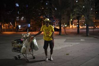 A homeless man is seen outside the Maracana stadium before a Carioca Championship 2020 football match between Flamengo and Bangu, in Rio de Janeiro, Brazil, on June 18, 2020, which is played behind closed doors as the city gradually eases its social distancing measures aimed at curbing the spread of the COVID-19 coronavirus. (Photo by MAURO PIMENTEL / AFP) (Photo by MAURO PIMENTEL/AFP via Getty Images)