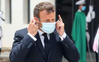 French President Emmanuel Macron puts on a face mask after arriving at Nouakchott--Oumtounsy International Airport on June 30, 2020, in Nouakchott, to attend a G5 Sahel summit. - The leaders of the G5 Sahel West African countries and their ally France are meeting to confer over their troubled efforts to stem a jihadist offensive unfolding in the region, six months after rebooting their campaign in Pau, southwestern France. (Photo by Ludovic MARIN / POOL / AFP) (Photo by LUDOVIC MARIN/POOL/AFP via Getty Images)