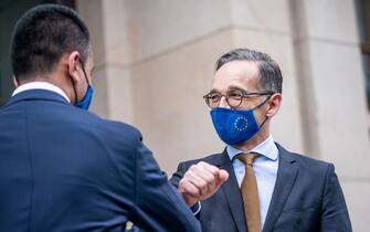 German Foreign Minister Heiko Maas (R) wears a face mask in the design of the European flag as he makes an ellbow bump with his Italian counterpart Luigi di Maio (L) leaving after talks, on June 5, 2020 in the courtyard of the Foreign Office in Berlin. (Photo by Michael Kappeler / POOL / AFP) (Photo by MICHAEL KAPPELER/POOL/AFP via Getty Images)
