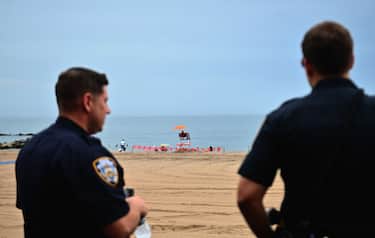 A lifeguard sits at Coney Island beach on July 1, 2020 in New York City, as beaches reopen to the public for swimming. - Hospitalizations and infections continue to hit new lows but officials fear a spike in rates elsewhere could cause an uptick in New York as it slowly reopens business and other activities. (Photo by Angela Weiss / AFP) (Photo by ANGELA WEISS/AFP via Getty Images)