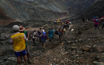 Rescuers recover bodies near the landslide area in the jade mining site in Hpakhant in Kachin state on July 2, 2020. - The battered bodies of more than 120 jade miners were pulled from a sea of mud after a landslide in northern Myanmar on July 2 after one of the worst-ever accidents to hit the treacherous industry. (Photo by Zaw Moe Htet / AFP) (Photo by ZAW MOE HTET/AFP via Getty Images)
