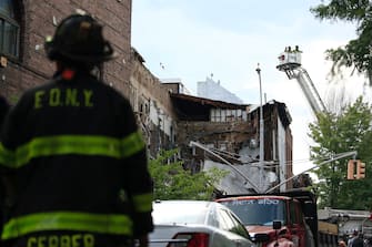 NEW YORK, NEW YORK - JULY 01: New York City Fire Department (FDNY) work at the scene after a three story building that housed the Body Elite Gym on the corner of Court and Union Streets collapsed on July 1, 2020 in the Carroll Gardens neighborhood of the Brooklyn borough of New York City. The collapse sent debris flying onto the sidewalk but no major injuries were reported. (Photo by Justin Heiman/Getty Images)