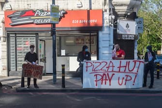 LONDON, ENGLAND - APRIL 25: Following the closure of several Pizza Hut restaurants due to Covid-19, the Croydon Solidarity Network protest outside in Lewisham over the plight of around forty Pizza Hut workers in South London who had not been paid for five weeks without being furloughed on April 25, 2020 in London, England. The British government has extended the lockdown restrictions first introduced on March 23 that are meant to slow the spread of COVID-19. (Photo by Guy Smallman/Getty Images)