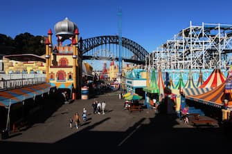 SYDNEY, AUSTRALIA - JULY 03: Guests visit Luna Park following a period of lockdown on July 03, 2020 in Sydney, Australia. Sydney's Luna Park has reopened to the public following its temporary closure on Monday 23 March in response to the COVID-19 pandemic. Restrictions on entertainment venues, weddings, community sport and other gatherings have been eased across NSW since 1 July, but strict physical distancing measures remain in place. (Photo by Lisa Maree Williams/Getty Images)