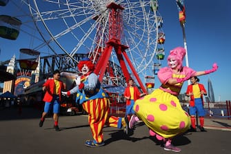 1253968229 SYDNEY, AUSTRALIA - JULY 03: Showtime performers including Blip the clown and Meringue social distance during a show at Luna Park on July 03, 2020 in Sydney, Australia. Sydney's Luna Park has reopened to the public following its temporary closure on Monday 23 March in response to the COVID-19 pandemic. Restrictions on entertainment venues, weddings, community sport and other gatherings have been eased across NSW since 1 July, but strict physical distancing measures remain in place. (Photo by Lisa Maree Williams/Getty Images)