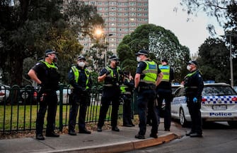 Police gather outside one of nine public housing estates which have been locked down in Melbourne on July 4, 2020 with more than 3000 residents in 1,345 units required to stay home due to an outbreak of the COVID-19 coronavirus. - The Australian state of Victoria recorded its second-highest daily increase in coronavirus cases, with 108 people diagnosed with the virus. (Photo by William WEST / AFP) (Photo by WILLIAM WEST/AFP via Getty Images)