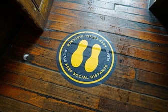 FALMOUTH, ENGLAND - JULY 4:  Social distancing signage at The Chain Locker pub as it reopens for business on July 4, 2020 in Falmouth, Cornwall, United Kingdom. The UK Government announced that Pubs, Hotels and Restaurants can open from Saturday, July 4th providing they follow guidelines on social distancing and sanitising. (Photo by Hugh R Hastings/Getty Images)