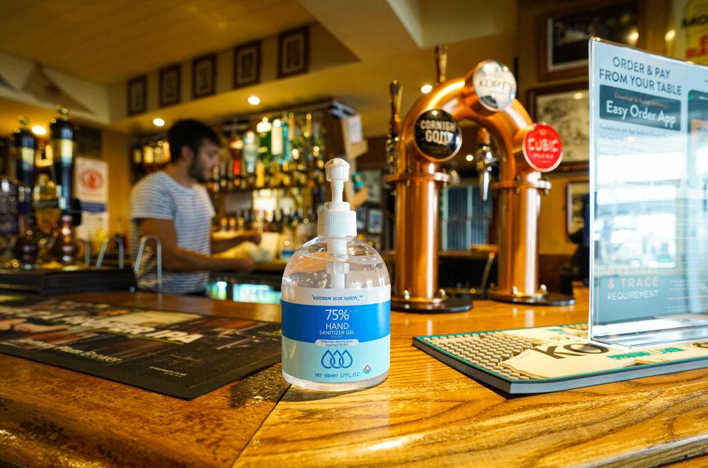 FALMOUTH, ENGLAND - JULY 4:  Sanitizer gel dispenser sits on the bar at the Chain Locker pub as it reopens for business on July 4, 2020 in Falmouth, Cornwall, United Kingdom. The UK Government announced that Pubs, Hotels and Restaurants can open from Saturday, July 4th providing they follow guidelines on social distancing and sanitising. (Photo by Hugh R Hastings/Getty Images)
