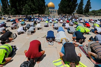 Palestinian Muslims perform friday prayer outside the Dome of the Rock Mosque, in Jerusalem's Al-Aqsa mosques compound on July 3, 2020, during the novel coronavirus pandemic. (Photo by AHMAD GHARABLI / AFP) (Photo by AHMAD GHARABLI/AFP via Getty Images)
