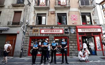 SPAIN PANDEMIC CORONAVIRUS COVID19 HOLIDAYS SANFERMINES epa08530493 Local police officers wear face masks as they stand guard next to City Hall in Pamplona, northern Spain, 06 July 2020. Pamplona's idiosyncratic Running of the Bulls, known as the Sanfermines, would have normally kicked off on 06 July with the 'Txupinazo' (an opening ceremony involving the firing of a pyrotechnic rocket from City Hall's main balcony). However, the bull-running festival made world-famous by Ernest Hemingway in his 1926 novel 'The Sun Also Rises' has been canceled this year due to the ongoing pandemic of the COVID-19 disease caused by the SARS-CoV-2 coronavirus. EPA/JESUS DIGES