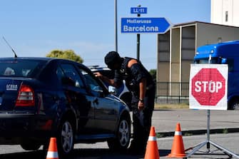 A member of the Catalan regional police force Mossos d'Esquadra controls a checkpoint on the road leading to Lleida on July 4, 2020. - Spain's northeastern Catalonia region locked down an area with around 200,000 residents around the town of Lerida following a surge in cases of the new coronavirus. (Photo by Pau BARRENA / AFP) (Photo by PAU BARRENA/AFP via Getty Images)