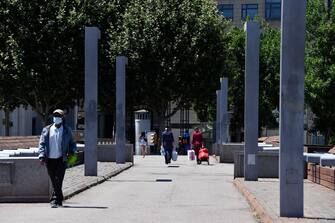 People walk with grocery bags in the Spanish town of Lleida on July 4, 2020. - Spain's northeastern Catalonia region locked down an area with around 200,000 residents around the town of Lerida following a surge in cases of the new coronavirus. (Photo by Pau BARRENA / AFP) (Photo by PAU BARRENA/AFP via Getty Images)