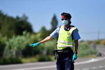 A member of the Catalan regional police force Mossos d'Esquadra controls a checkpoint on the Corbins highway near Lleida on July 4, 2020. - Spain's northeastern Catalonia region locked down an area with around 200,000 residents around the town of Lerida following a surge in cases of the new coronavirus. (Photo by Pau BARRENA / AFP) (Photo by PAU BARRENA/AFP via Getty Images)