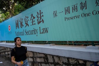 1223485890 HONG KONG, CHINA - JUNE 30: Pedestrians walks past a government-sponsored advertisement promoting a new national security law on June 30, 2020 in Hong Kong, China. (Photo by Billy H.C. Kwok/Getty Images)