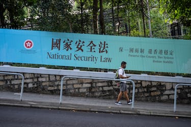HONG KONG, CHINA - JUNE 30: Pedestrians walks past a government-sponsored advertisement promoting a new national security law on June 30, 2020 in Hong Kong, China. (Photo by Billy H.C. Kwok/Getty Images)