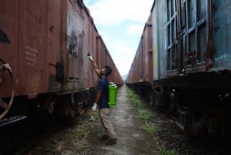 epaselect INDIA PANDEMIC CORONAVIRUS COVID19 epaselect epa08530672 A worker sprays disinfectant on trains to contain the spread of Covid19 coronavirus, during the total lockdown in Guwahati, India, 06 July 2020. Guwahati is the worst coronavirus-affected city in Assam and began a strict, two-week lockdown from the evening of 28 June 2020. EPA/STR