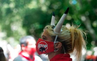 A pro-animal rights activist waits for the start of an action to celebrate the cancellation of the San Fermin Festival's bullfights and bull-running called by the People for the Ethical Treatment of Animals (PETA) and Anima Naturalis pro-animal groups in Pamplona, on July 7, 2020. - The 2020 edition of the San Fermin Festival has been cancelled as part of preventive measures to fight the spread of the novel coronavirus. (Photo by ANDER GILLENEA / AFP) (Photo by ANDER GILLENEA/AFP via Getty Images)