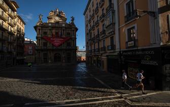 PAMPLONA, SPAIN - JULY 07: People jog and walk at Plaza Consistorial after the San Fermin Festival was cancelled earlier this year, on July 07, 2020 in Pamplona, Spain. The annual Bull-Running Festival was canceled this year 2020 due to the Coronavirus (COVID-19) pandemic, The last time this happened was in 1938, during the Spanish Civil War. (Photo by Pablo Blazquez Dominguez/Getty Images)