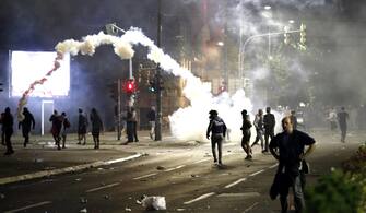 SERBIA PROTEST PANDEMIC CORONAVIRUS COVID19 epa08533694 Tear gas flies over protesters outside the Serbian Parliament building in Belgrade, Serbia, 07 July 2020 (issued 08 July 2020). Hundreds gathered to protest after President Aleksandar Vucic announced that a weekend curfew would be enforced amid a surge in coronavirus cases. EPA/KOCA SULEJMANOVIC