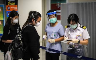 A health official checks the forms of an incoming passenger during a health assessment at a checkpoint for people flying in from a list of countries and territories that include China, Hong Kong, Macau, South Korea, Iran and Italy, as a precautionary measure against the spread of the COVID-19 coronavirus at Suvarnabhumi Airport in Bangkok on March 9, 2020. (Photo by VIVEK PRAKASH / AFP) (Photo by VIVEK PRAKASH/AFP via Getty Images)