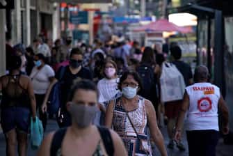 People walk in the surroundings of the Saenz Pena square at the Tijuca neighborhood in Rio de Janeiro, Brazil on July 8, 2020, amid the new coronavirus pandemic. - Brazilian President Jair Bolsonaro has tested positive for the coronavirus after months of downplaying the dangers of the disease. (Photo by MAURO PIMENTEL / AFP) (Photo by MAURO PIMENTEL/AFP via Getty Images)