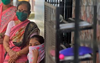 Residents wait for their turn to get screened during a medical screening for the COVID-19 coronavirus, at a residential society in Mumbai on July 10, 2020. - Hospitals in densely populated cities such as Mumbai and Delhi are struggling to cope with the epidemic, and the country now has around 720,000 infections -- the world's third-highest. (Photo by Punit PARANJPE / AFP) (Photo by PUNIT PARANJPE/AFP via Getty Images)