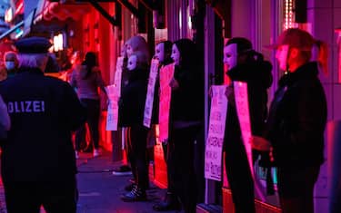 HAMBURG, GERMANY - JULY 11: Sex workers protest against lockdown measures that are preventing brothels from reopening in Hamburg's red light district during the coronavirus pandemic on July 11, 2020 in Hamburg, Germany. Sex workers across Germany are demanding an easing of ongoing lockdown measures that are preventing them from resuming their work. While authorities have lifted lockdown measures for most businesses in Germany, some, especially for those that involve close physical contact, remain in place. Legal sex workers say they are being treated unfairly, claiming they have developed adequate hygienic measures to prevent the spread of the virus and point out that other businesses that require similar physical proximity, such as hair salons and tattoo parlours, have been allowed to reopen. (Photo by Morris MacMatzen/Getty Images)