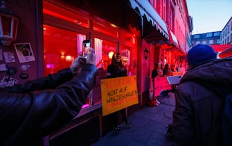 HAMBURG, GERMANY - JULY 11: Sex workers protest against lockdown measures that are preventing brothels from reopening in Hamburg's red light district during the coronavirus pandemic on July 11, 2020 in Hamburg, Germany. Sex workers across Germany are demanding an easing of ongoing lockdown measures that are preventing them from resuming their work. While authorities have lifted lockdown measures for most businesses in Germany, some, especially for those that involve close physical contact, remain in place. Legal sex workers say they are being treated unfairly, claiming they have developed adequate hygienic measures to prevent the spread of the virus and point out that other businesses that require similar physical proximity, such as hair salons and tattoo parlours, have been allowed to reopen. (Photo by Morris MacMatzen/Getty Images)