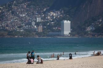 RIO DE JANEIRO, BRAZIL - JULY 12: City hall inspectors warn and notify beach goers of new rules at Arpoador Beach amidst the coronavirus (COVID-19) pandemic on July 12, 2020 in Rio de Janeiro, Brazil. The practice of physical activities on boardwalks and individual sports at sea is allowed. However, the use of chairs and tents on the sand is still prohibited. Mayor Marcelo Crivella warned of the intensification of inspection and the imposition of a fine for those who do not comply with the rules. (Photo by Bruna Prado/Getty Images)