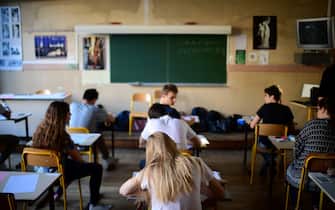 Pupils wait for the start of the first written test in philosophy as part of the Baccalaureat (France's high school diploma) at a school in Paris on June 15, 2017. / AFP PHOTO / Martin BUREAU        (Photo credit should read MARTIN BUREAU/AFP via Getty Images)