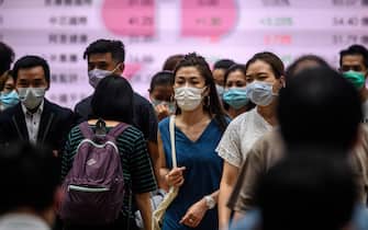 Pedestrians wear face masks as they cross a road in Hong Kong on July 10, 2020, as the city experiences new local outbreaks of the COVID-19 coronavirus. - The finance hub recorded 38 new confirmed cases on July 10, thirty-two of which were locally transmitted. (Photo by Anthony WALLACE / AFP) (Photo by ANTHONY WALLACE/AFP via Getty Images)
