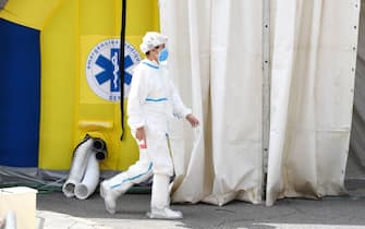 A healthcare worker wearing protective gear walks past a field hospital set up for coronavirus cases outside the CAP Prat de la Riba primary care centre in Lerida (Lleida) on July 13, 2020. - A local court suspended a home confinement order imposed on more than 200,000 people in the Spanish region of Catalonia after an upsurge in virus cases. Catalonia officials ordered the home confinement on the city of Lerida and its surrounding areas a week after the zone had been placed under less strict lockdown. (Photo by Pau BARRENA / AFP) (Photo by PAU BARRENA/AFP via Getty Images)