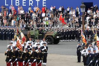 French President Emmanuel Macron (R) arrives with Chief of the Defence Staff General Francois Lecointre prior to the annual Bastille Day military ceremony on the Place de la Concorde in Paris, on July 14, 2020. - France holds a reduced version of its traditional Bastille Day parade this year due to safety measures over the COVID-19 (novel coronavirus) pandemic, and with the country's national day celebrations including a homage to health workers and others fighting the outbreak. (Photo by Ludovic Marin / POOL / AFP) (Photo by LUDOVIC MARIN/POOL/AFP via Getty Images)