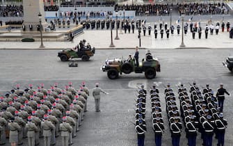 French President Emmanuel Macron (R) arrives with Chief of the Defence Staff General Francois Lecointre prior to the annual Bastille Day military ceremony on the Place de la Concorde in Paris, on July 14, 2020. - France holds a reduced version of its traditional Bastille Day parade this year due to safety measures over the COVID-19 (novel coronavirus) pandemic, and with the country's national day celebrations including a homage to health workers and others fighting the outbreak. (Photo by Thomas SAMSON / AFP) (Photo by THOMAS SAMSON/AFP via Getty Images)
