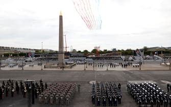 French elite acrobatic flying team "Patrouille de France" (PAF) performs a flying display of the French national flag over the Luxor Obelisks during annual Bastille Day military ceremony on the Place de la Concorde in Paris, on July 14, 2020. - France holds a reduced version of its traditional Bastille Day parade this year due to safety measures over the COVID-19 (novel coronavirus) pandemic, and with the country's national day celebrations including a homage to health workers and others fighting the outbreak. (Photo by Thomas SAMSON / AFP) (Photo by THOMAS SAMSON/AFP via Getty Images)