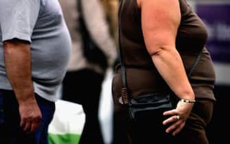 72133063 GLASGOW, UNITED KINGDOM - OCTOBER 10: An overweight person walks through Glasgow city centre on October 10, 2006 in Glasgow, Scotland. According to government health maps published today, people in the north of England lead less healthy lifestyles compared to those in the south. The United Kingdom is also the fattest country in Europe, according to a new study of obesity rates to be released today. The "Health Profile of England" report, compiled from government data, said some 24 percent of people in England, Wales, Scotland and Northern Ireland are obese. (Photo by Jeff J Mitchell/Getty Images)