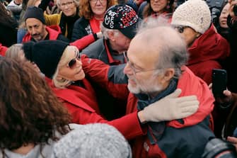 WASHINGTON, DC - NOVEMBER 08: Actress Jane Fonda (L) embraces Jerry Greenfield of Ben and Jerry's ice cream maker at the conclusion of her "Fire Drill Fridays" rally protesting against climate change outside the White House November 08, 2019 in Washington, DC. The demonstrators temporarily blocked the White House northwest gate and said they were ready to be arrested. No one was arrested before they ended the protest and ate free ice cream.  (Photo by Chip Somodevilla/Getty Images)