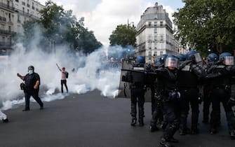 French gendarmes disperse protesters during a demonstration in Paris, on July 14, 2020, as part of a nationwide day of protests by health workers to demand better work conditions. - Health care workers are protesting in France on the country's National day to demand more for their sector a day after the government and unions signed an agreement giving over eight billion euros in pay rises, with the prime minister admitting the move was overdue in view of the coronavirus pandemic. (Photo by Zakaria ABDELKAFI / AFP) (Photo by ZAKARIA ABDELKAFI/AFP via Getty Images)