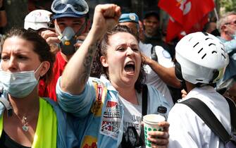 A protester shouts slogans during a demonstration in Paris, on July 14, 2020, as part of a nationwide day of protests by health workers to demand better work conditions. - Health care workers are protesting in France on the country's National day to demand more for their sector a day after the government and unions signed an agreement giving over eight billion euros in pay rises, with the prime minister admitting the move was overdue in view of the coronavirus pandemic. (Photo by Zakaria ABDELKAFI / AFP) (Photo by ZAKARIA ABDELKAFI/AFP via Getty Images)