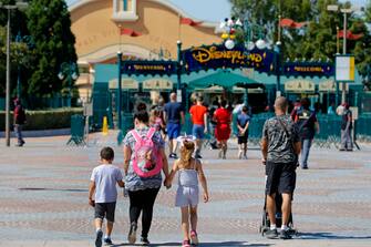 PARIS, FRANCE - JULY 13: People with annual passes wearing protective face masks arrive to visit Disneyland Paris on July 13, 2020 in Marne-la-Vallee, near Paris, France. After four months of closure, the amusement park officially reopens its doors on Wednesday July 15 with compulsory reservations online. The Disneyland Paris and Walt Disney studio parks have been closed since mid-March due to the coronavirus epidemic (COVID 19). (Photo by Chesnot/Getty Images)